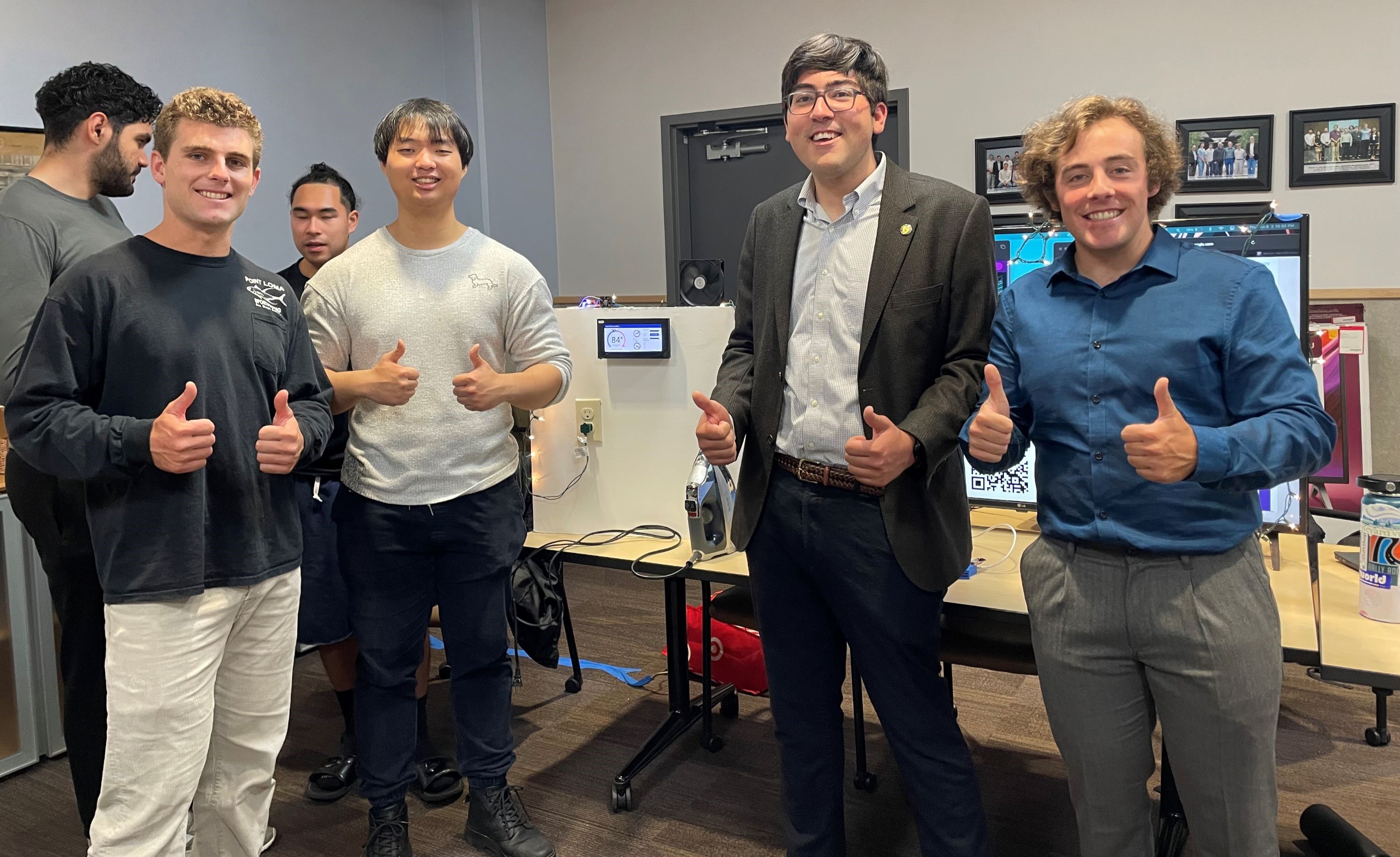 Dominic Orlando with the Aegis team presenting the first iteration of their home energy monitoring solution. They won best MVP award.